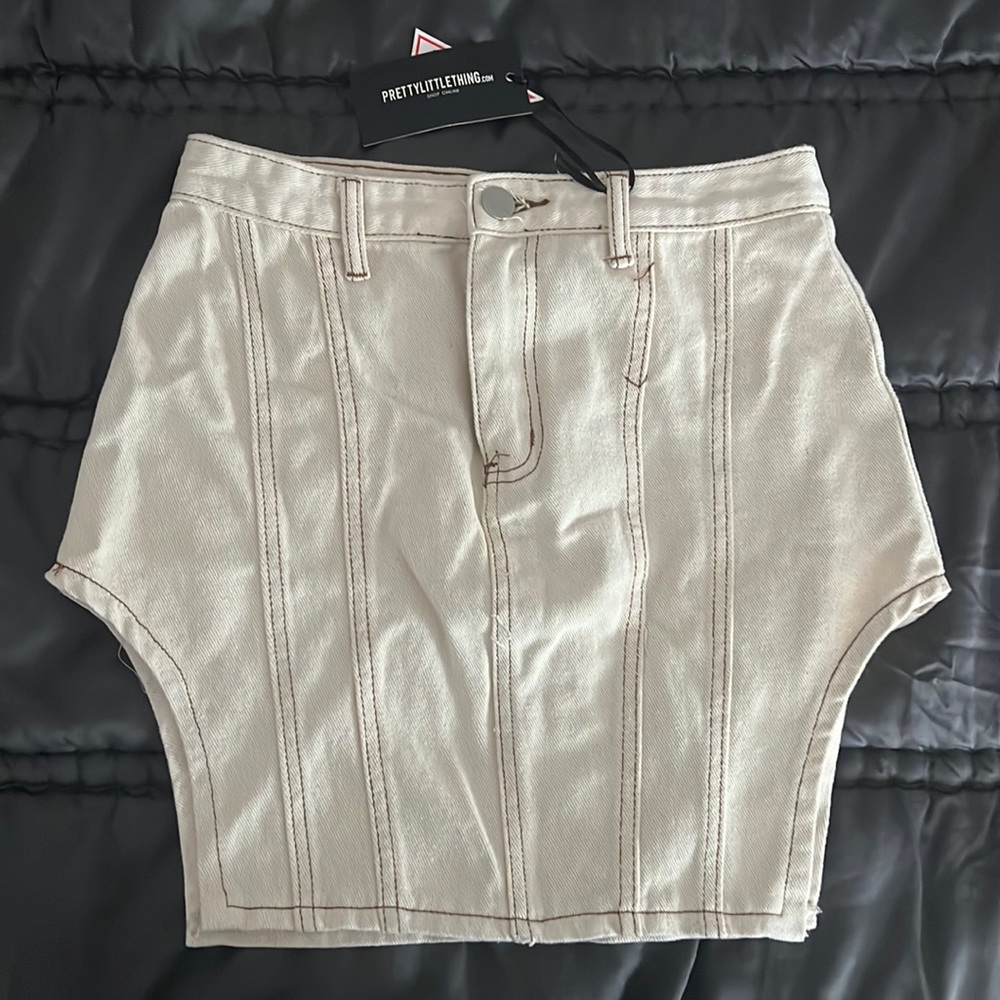 Never worn! Cream denim skirt with contrast stitch and cut out hem both sides